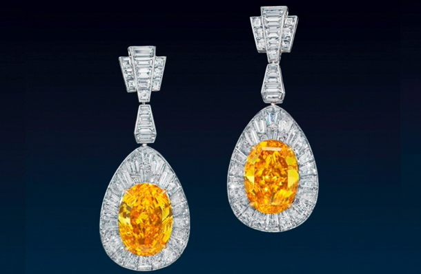 A pair of fancy vivid orange-yellow diamond earrings sold for almost $8m at Christie's Hong Kong.