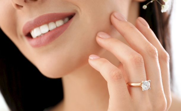 Young bride wearing beautiful engagement ring, closeup